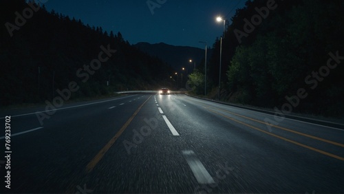 A car driving on a road at night.