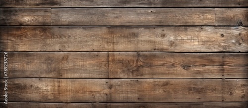 A closeup of a brown hardwood wall panel with a grainy texture and beige wood stain. The rectangular planks create a beautiful pattern, showcasing the natural beauty of the building material