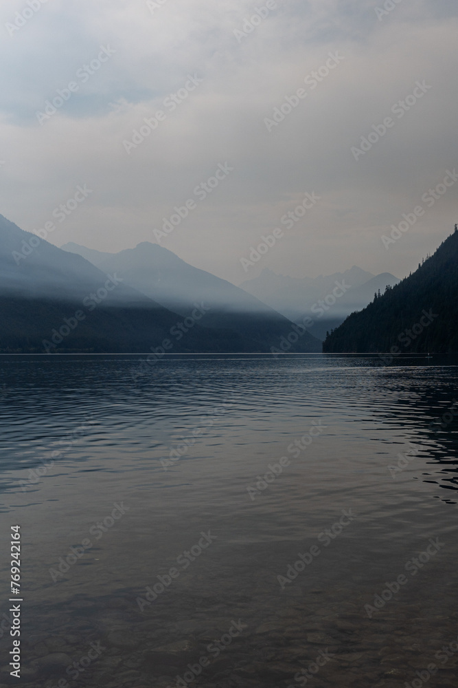 Beautiful waters of the Chilliwack Lake park foggy clouds and mountains