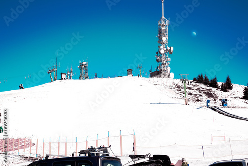 The ski lift under the moon. The top of Mottarone mountain (1491 meters above sea level) on a winter morning.  Ski lift and ski slope. Piedmont - Italy.