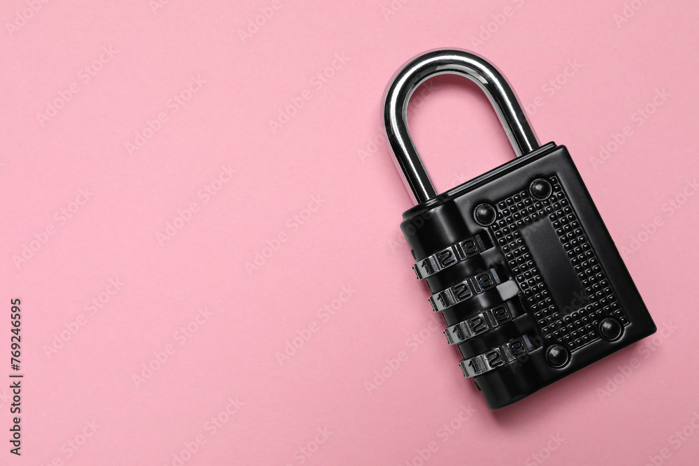 Steel combination padlock on pink background, top view. Space for text Steel combination padlock on pink background, top view. Space for text