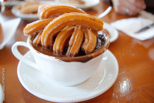 Fotografía de churros tradicionales de España con chocolate , en una churrería tradicional photo