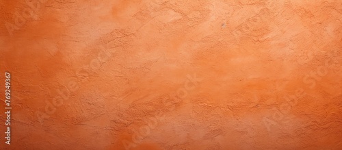 A detailed view of a hardwood flooring with a beautiful peach, amber, and orange wall texture. The pattern resembles fur with various tints and shades of brown