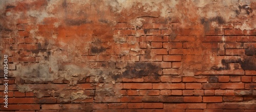 Detailed closeup of weathered brick wall with peeling paint, showcasing the beautiful textures and colors of the brickwork against a backdrop of green grass