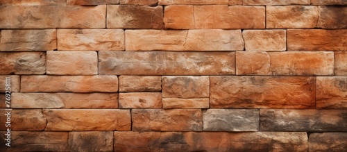 A detailed closeup shot of a brown brick wall showcasing the rectangular bricks and intricate brickwork. The wall is constructed with composite material resembling stone and rock