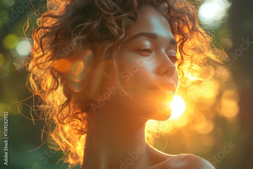 The back of a person with curly hair highlighted by sunlight, focus on hair texture