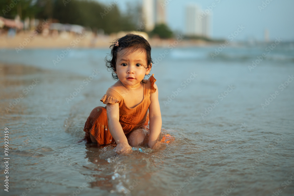 happy toddler baby girl playing toy and water on sea beach happy toddler baby girl playing toy and water on sea beach