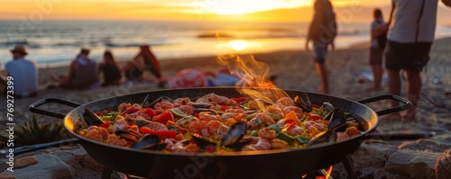 Sunset paella cooking on the beach friends gathering photo