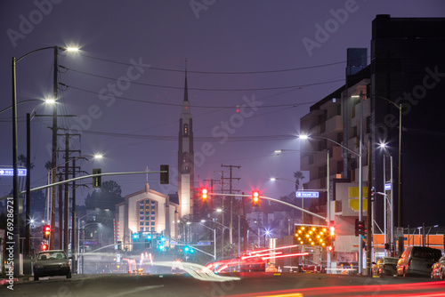 Inglewood, California, USA - October 7, 2022: Evening traffic passes through historic downtown Inglewood. photo