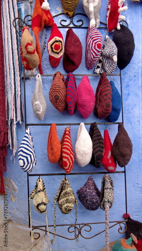 Vendor selling colorful hats in the medina in Chefchaouen, Morocco © Angela