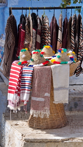Vendor selling colorful hats in the medina in Chefchaouen, Morocco © Angela