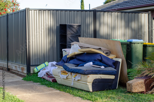 Quadro su tela household waste or hard rubbish of a discarded sofa, rugs and assorted debris piled at front yard outside a residential home ready for collection