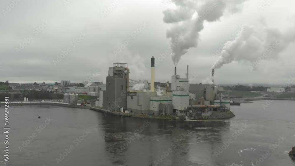 Aerial shot of the Irving Pulp and Paper factory shooting toxic smoke into the air on a cloudy day near the reversing falls. Aerial shot of the Irving Pulp and Paper factory shooting toxic smoke into the air on a cloudy day near the reversing falls.