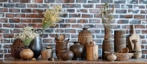 Home decor items on table near brick wall