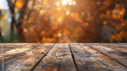 Empty wooden table with autumn blurred background with bokeh.