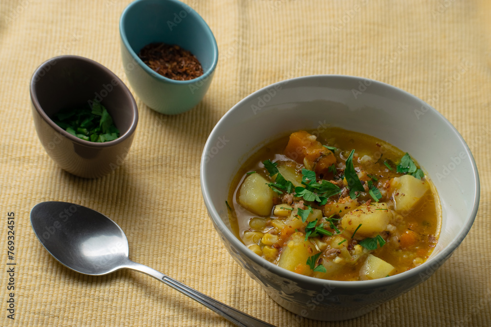 Typical Chilean food called Carbonada. It is a broth whose ingredients are: cooked potato, pumpkin, corn, parsley or cilantro, peas and beef (cut or ground)