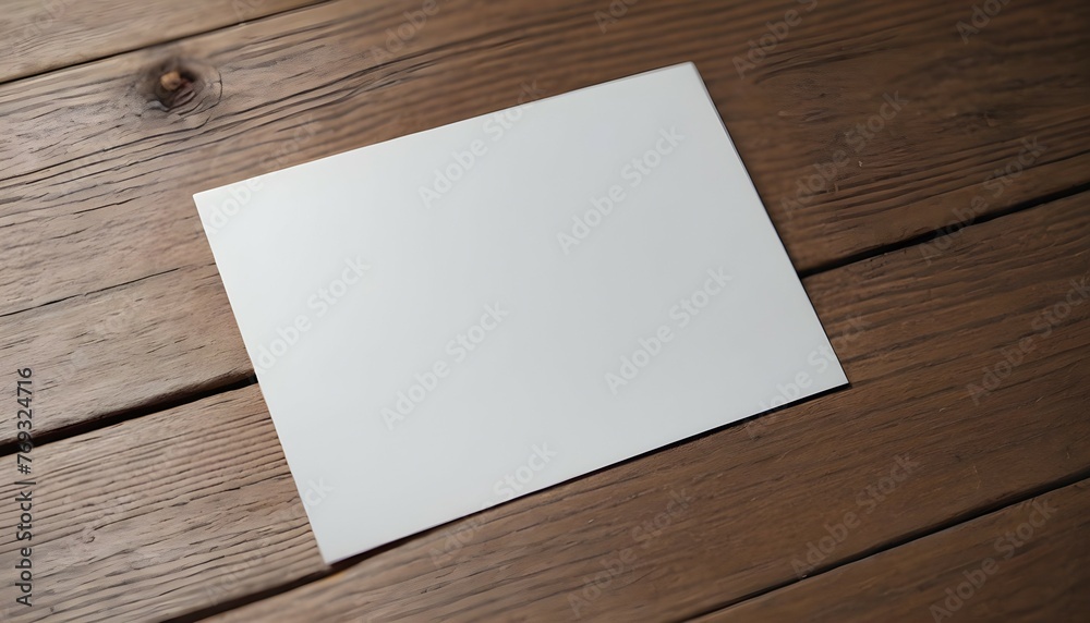 An overhead view of a blank white paper card placed on a wooden surface, slightly tilted to the side, awaiting heartfelt words to be penned. - obrazy, fototapety, plakaty 
