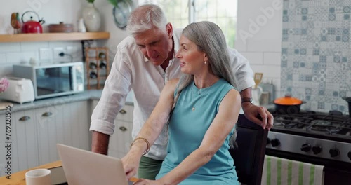 Laptop, happy and mature couple in kitchen networking on social media, website or the internet. Smile, technology and senior man and woman browsing on computer with conversation in apartment. photo