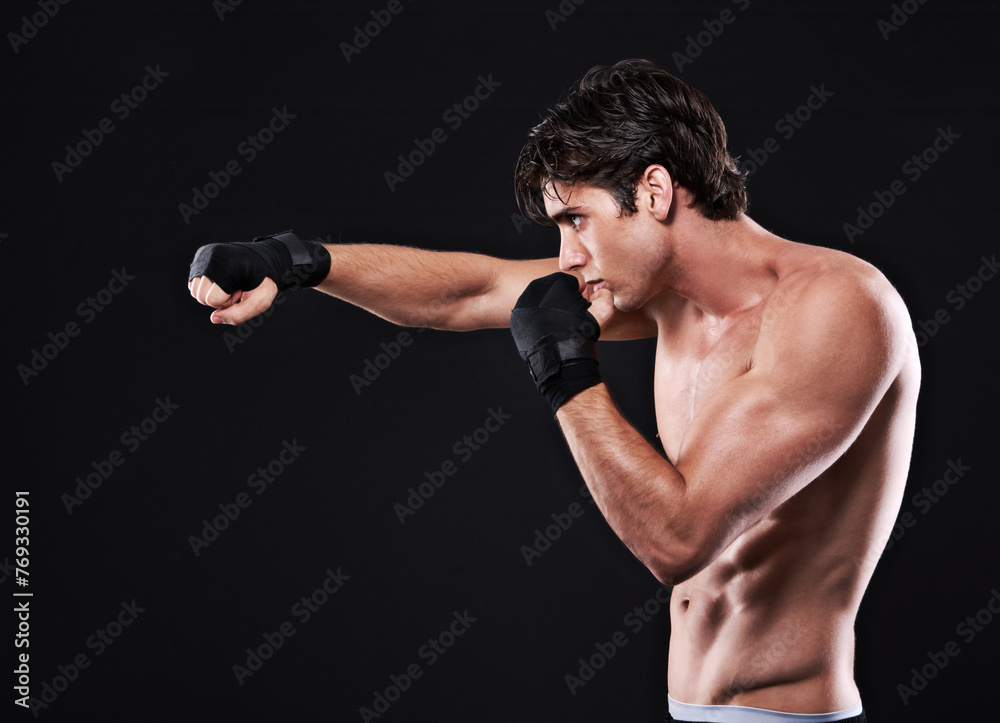 Fitness, mma and man punching in studio for exercise, challenge or competition training for boxing. Power, muscle or profile of champion boxer at workout with confidence, fight and black background