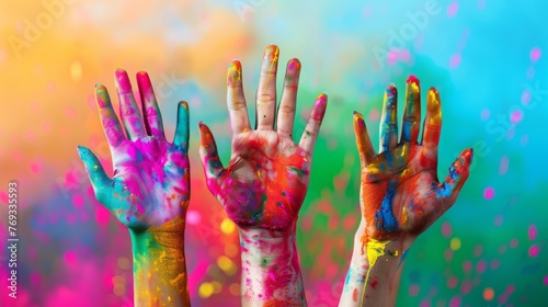 India Holi festival, colorful raised hands with colorful blurry background, copy and text space, 16:9