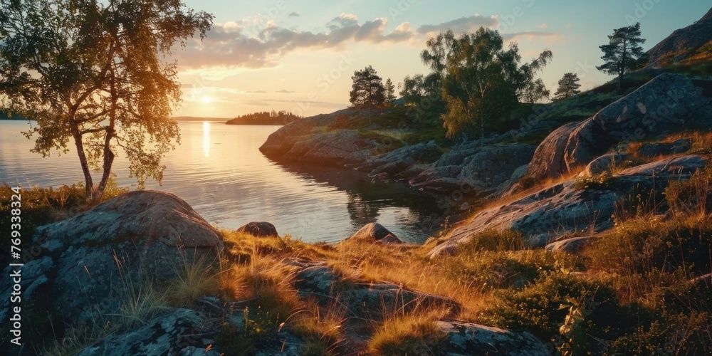A beautiful sunset over a lake with a rocky shoreline