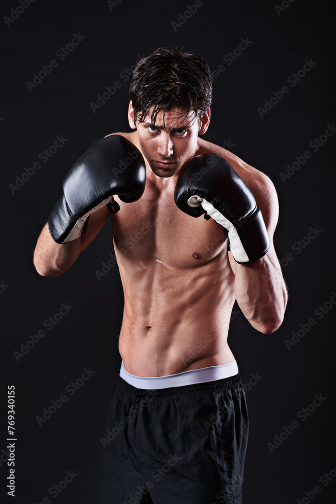 Man, portrait and boxing gloves in studio for exercise fight or martial arts training or performance, black background or gym. Male person, face and self defence fitness for athlete, mockup or punch