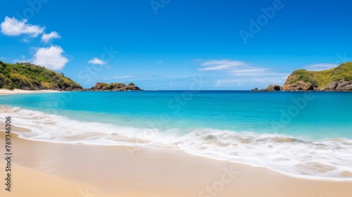 Sandy beach with blue sky and pristine sea in nature