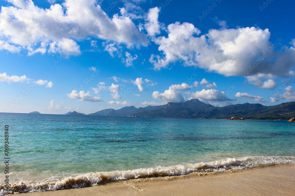 The azure blue waters off the Anse Soleil Beach in Mahe Island, Seychelles The azure blue waters off the Anse Soleil Beach in Mahe Island, Seychelles