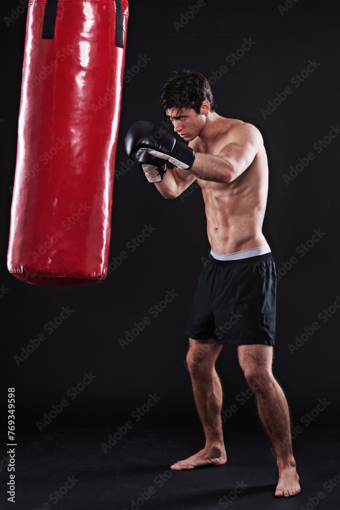 Man, gloves and boxing bag for workout practice or cardio exercise for health, fighter or black background. Male person, punch and martial arts training in studio on mockup for muscle, gym or strong