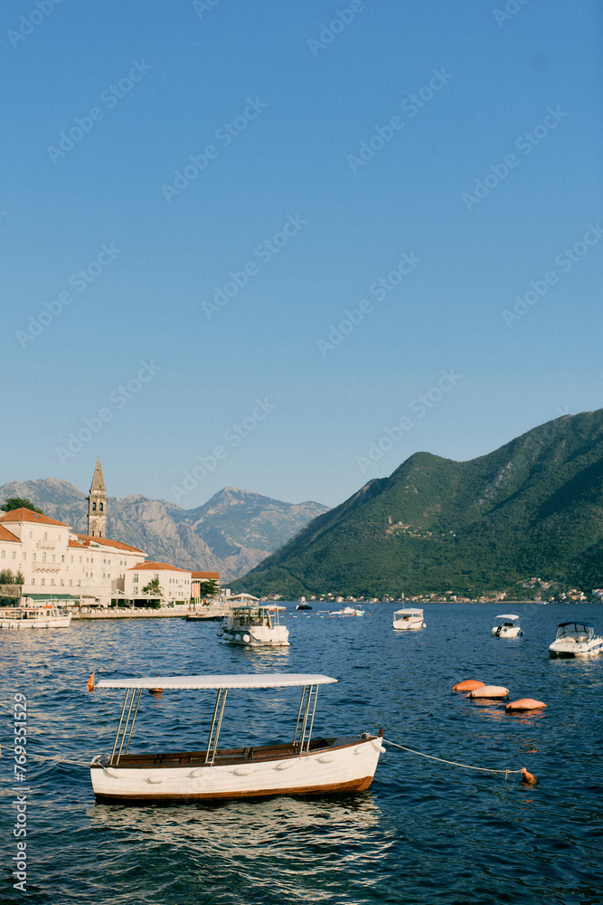 Small excursion boats are moored in the sea off the coast of Perast. Montenegro