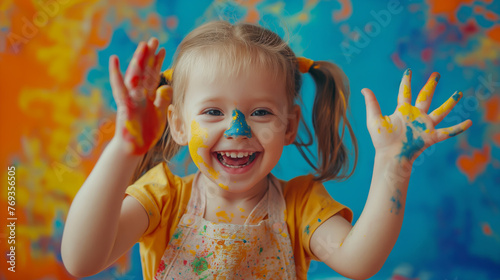 portrait Funny child girl draws laughing shows hands dirty with paint on Coral background professional photography.