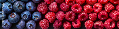 A cluster of ripe raspberries arranged closely together, showcasing a vibrant spectrum of red and purple hues, background, wallpaper, banner photo
