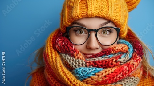 A woman dressed in a knitted hat and scarf