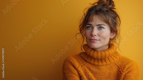 A woman in a yellow sweater strikes a pose for a picture © Tetiana
