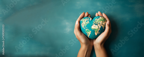 World environment day concept, hand opens palms hold heart shaped earth globe, earth day.