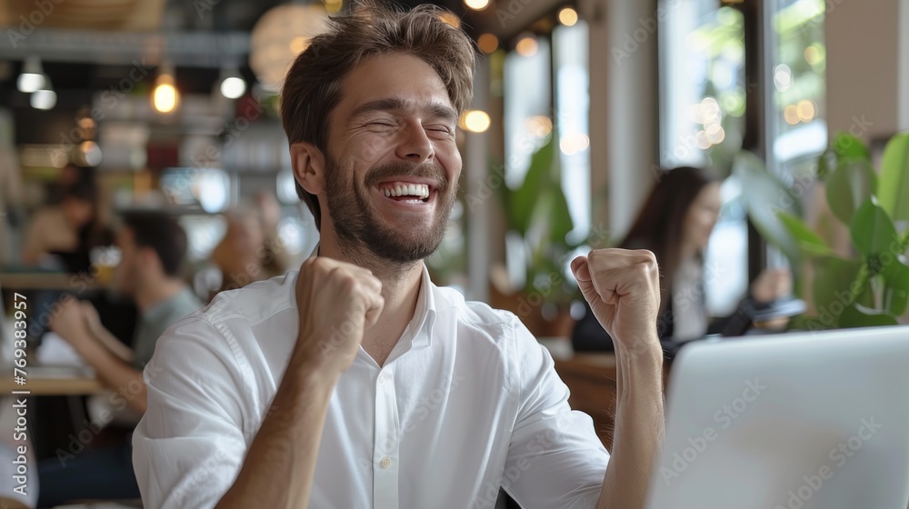 A man is smiling and holding his hands up in the air. A man is smiling and holding his hands up in the air.