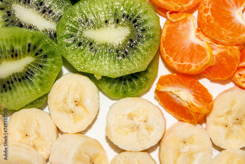 Banana.Kiwi.Mandarin.Slicing of fruits.Fruit background.Fruit mix. © begun1983