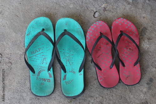 Two pairs of slippers on the cement floor. Two house slippers for men and women. Showing couple love concept and family concept.
