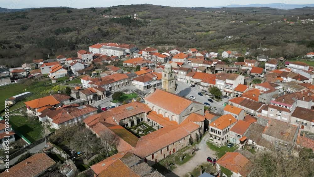 Drone panoramic orbit around collegiate church courtyard and bell tower in Ourense Drone panoramic orbit around collegiate church courtyard and bell tower in Ourense