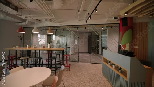 Stylish office break room with a communal vibe, featuring wooden furnishings and industrial touches