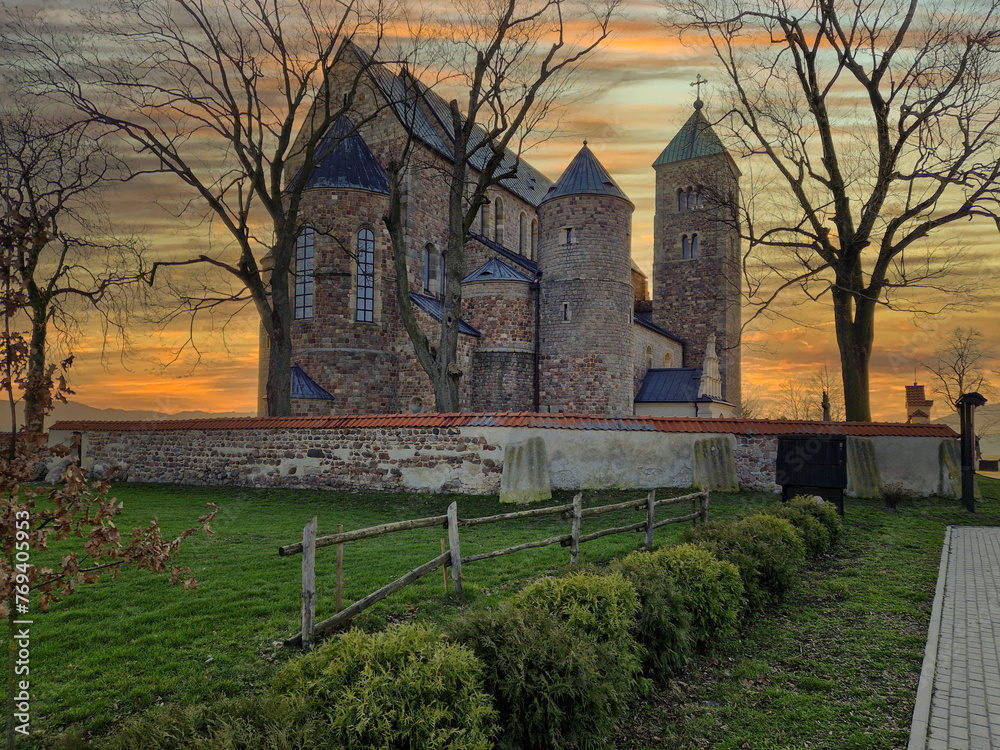 Historic buildings of the church and village in Tum, Poland. - obrazy, fototapety, plakaty 