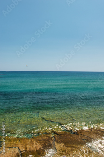 HERSONISSOS, GREECE - 22 JUNE 2023: Beach in Sarantaris village, municipal division Hersonissos. Hersonissos - a city in the north of Crete, located between the Mediterranean and Aegean seas. photo