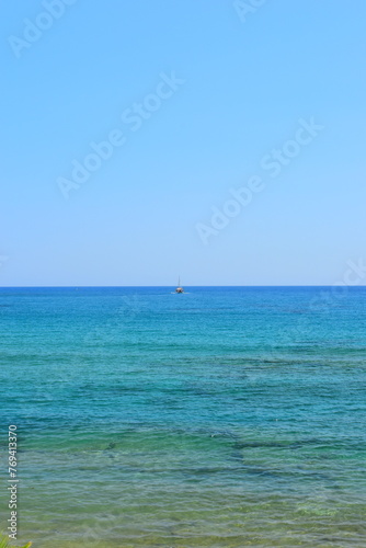 HERSONISSOS, GREECE - 22 JUNE 2023: Beach in Sarantaris village, municipal division Hersonissos. Hersonissos - a city in the north of Crete, located between the Mediterranean and Aegean seas.