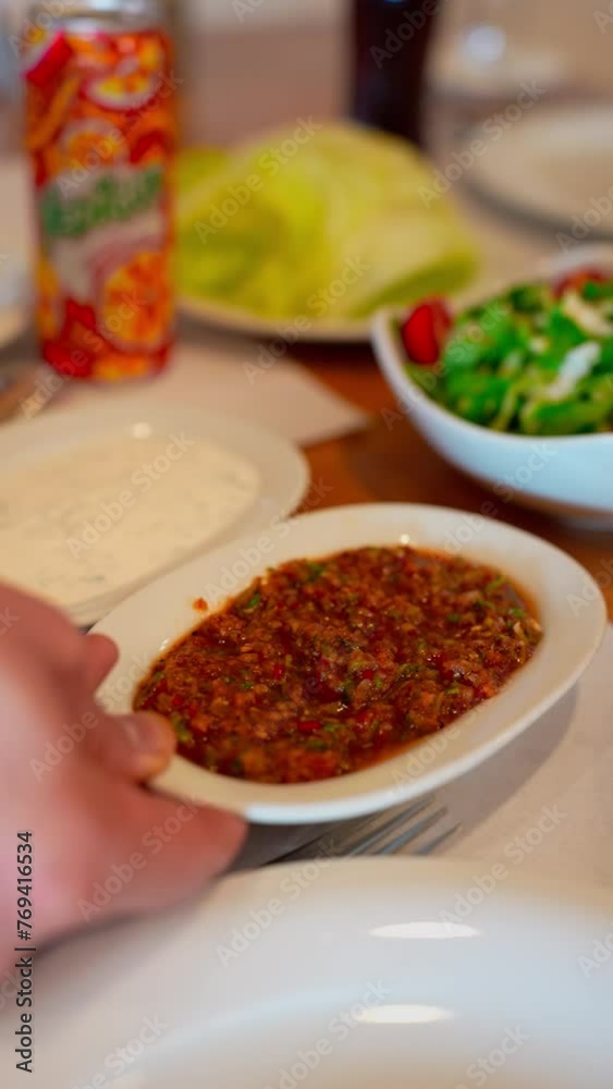 Traditional Turkish cuisine appetizers are left on the table, spicy paste and yoghurt. Traditional Turkish cuisine appetizers are left on the table, spicy paste and yoghurt.