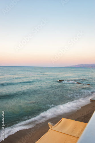 HERSONISSOS, GREECE - 22 JUNE 2023: Beach in Sarantaris village, municipal division Hersonissos. Hersonissos - a city in the north of Crete, located between the Mediterranean and Aegean seas. photo