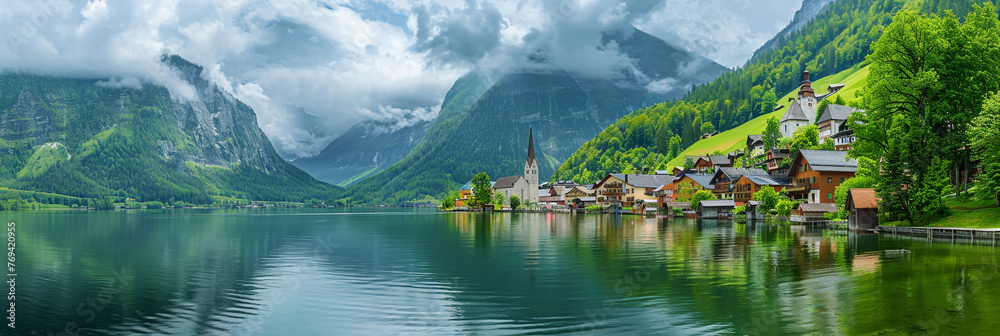 Naklejka premium Beautiful European small town by the lake and mountain