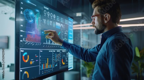 Male statistician use interactive whiteboard presentation touchscreen to look at charts in creative office.