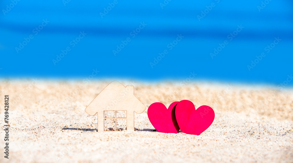 Fototapeta premium Symbol of home and love on the sea shore