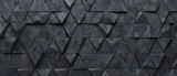 Abstract triangular dark black anthracite gray stone concrete cement mosaic tiles wallpaper texture with geometric ribbed triangles background banner.