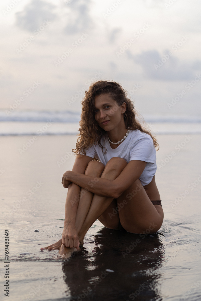 Portrait of cheerful young happy curly hair woman on the beach. Bali Portrait of cheerful young happy curly hair woman on the beach. Bali